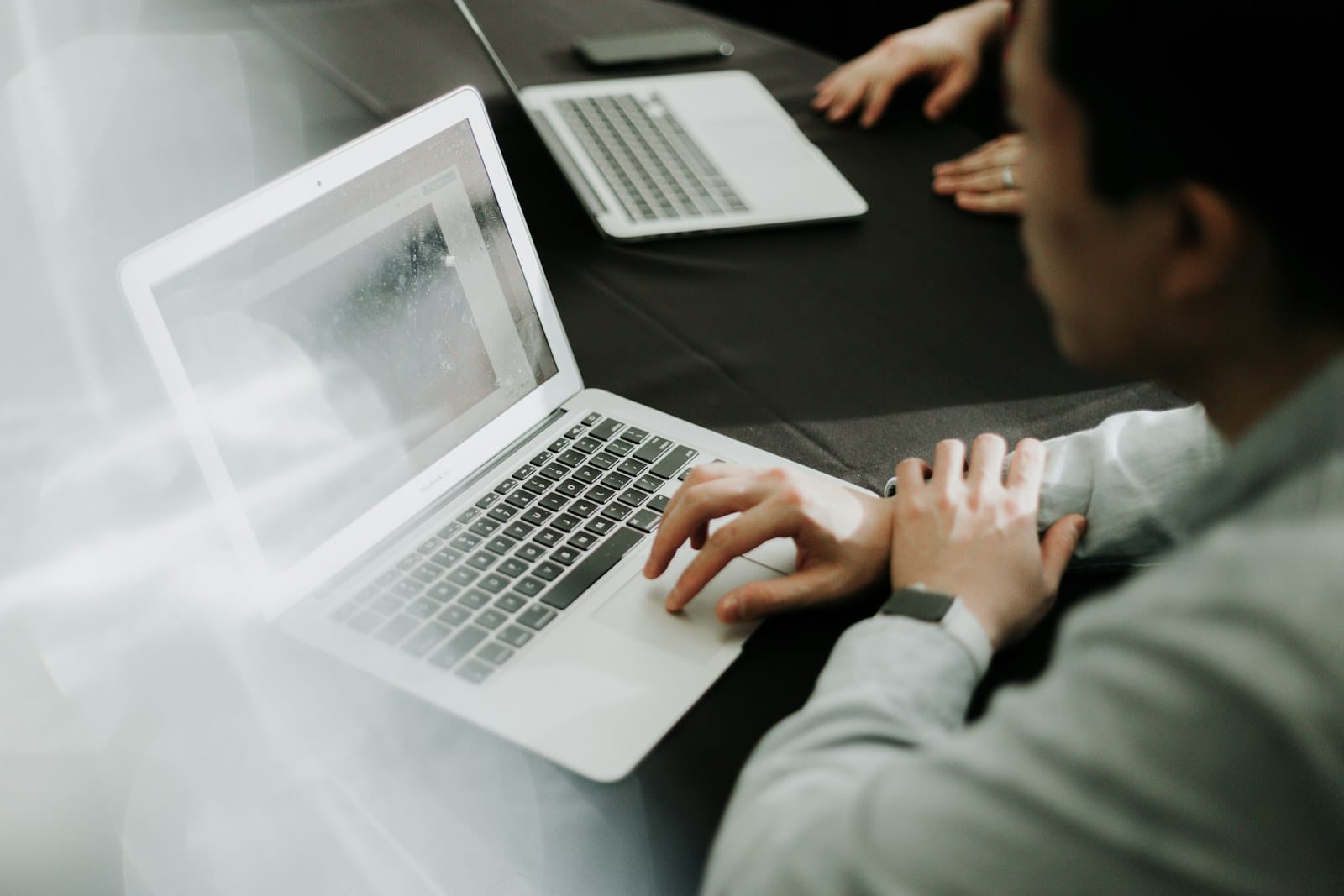 A person working at a laptop in an office.