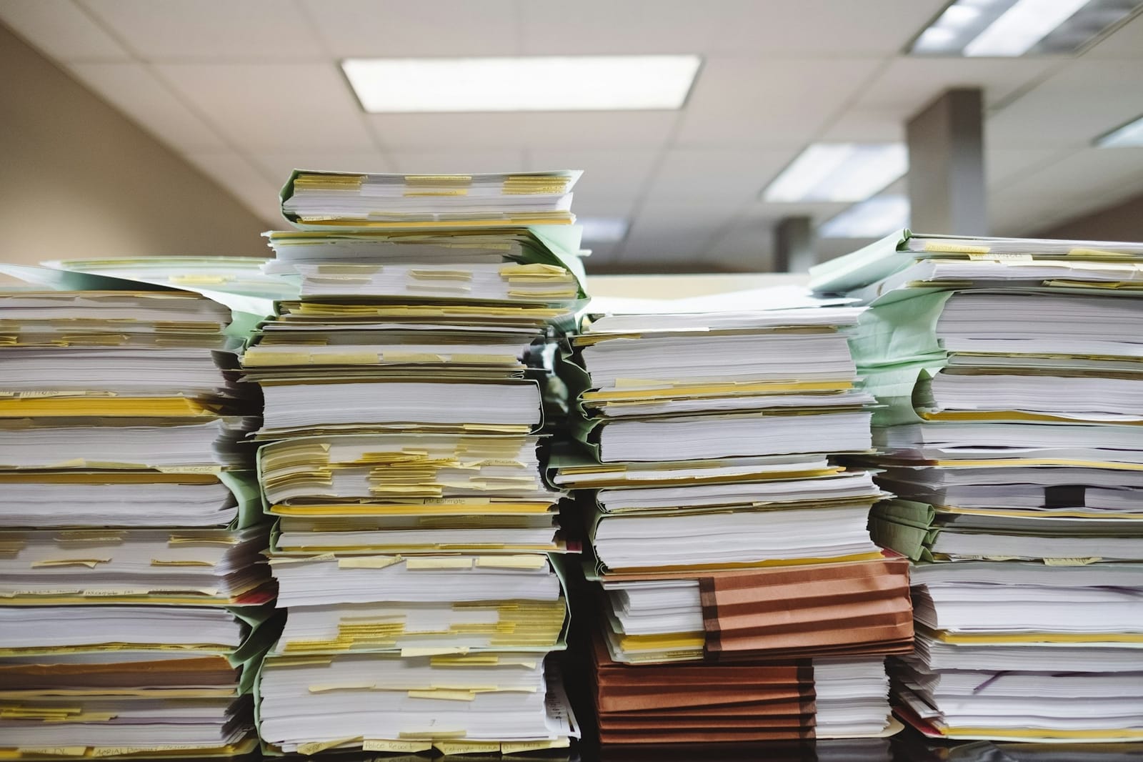 An analyst reviewing public-record documents at a desk.
