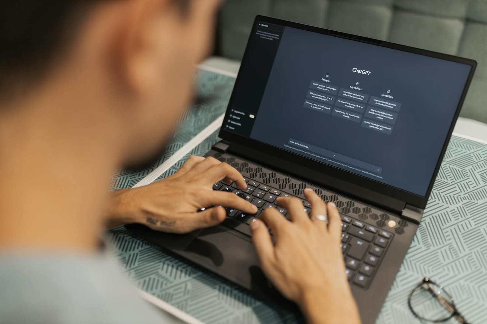 A person working with AI software on a laptop.